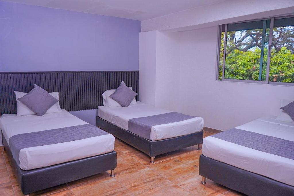 Postel nebo postele na pokoji v ubytování Hotel Palmas del Estadio