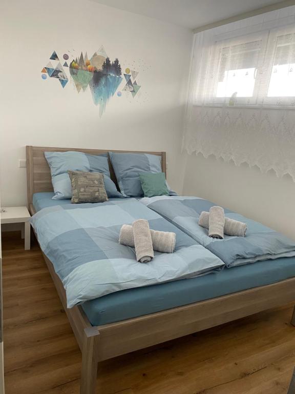 a large bed with blue sheets and pillows on it at Marl Central Apartment in Marl