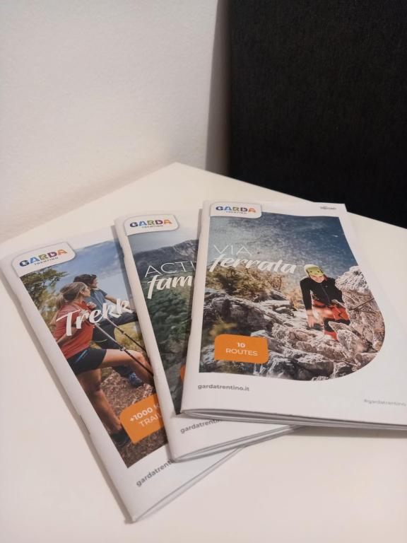 three magazines sitting on top of a table at Da Sandro Holidays Apartment in Arco