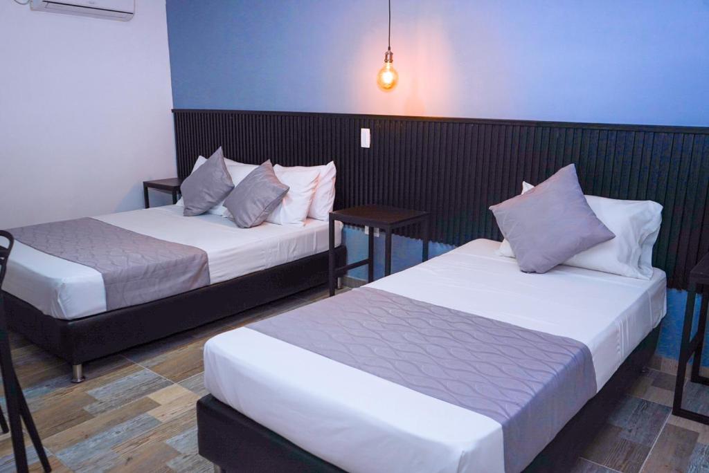 Postel nebo postele na pokoji v ubytování Hotel Palmas del Estadio