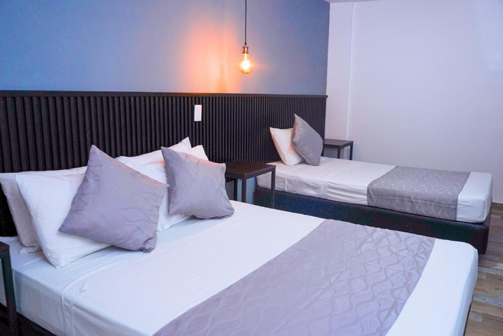 Postel nebo postele na pokoji v ubytování Hotel Palmas del Estadio