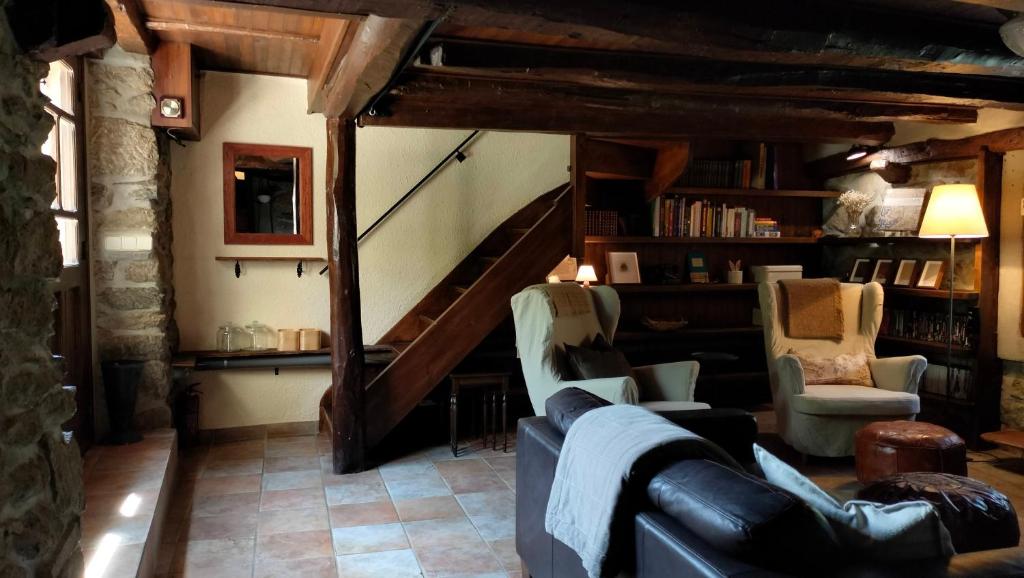 a living room with a couch and a staircase at Maison en Cerdagne avec belle vue in Enveitg