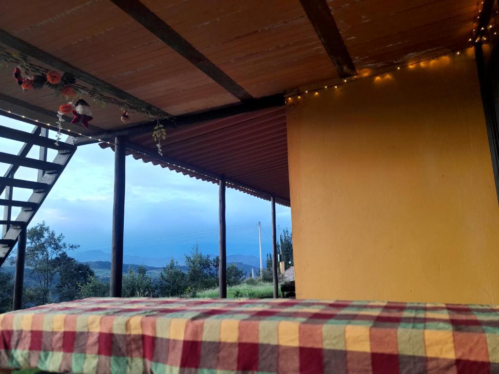 Postel nebo postele na pokoji v ubytování Hostal Espeletia Amarilla