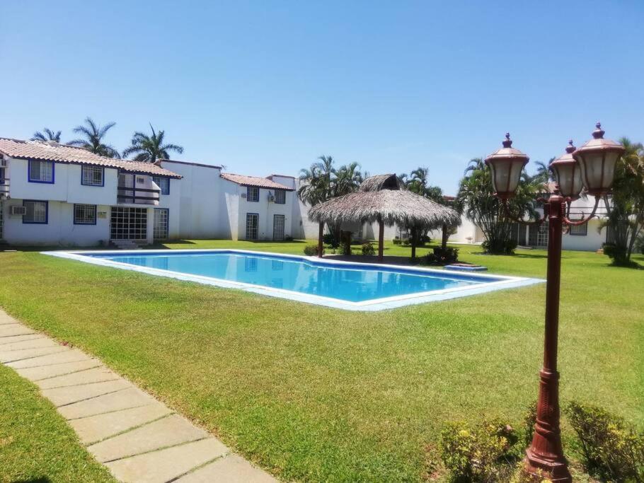 a swimming pool in a yard with a light pole at Escape Acapulco in Acapulco