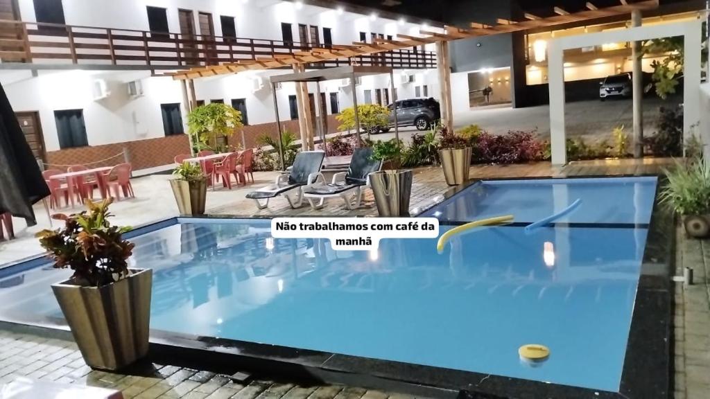 a villa with a swimming pool in a resort at Pousada Sophia Beach in Salinópolis