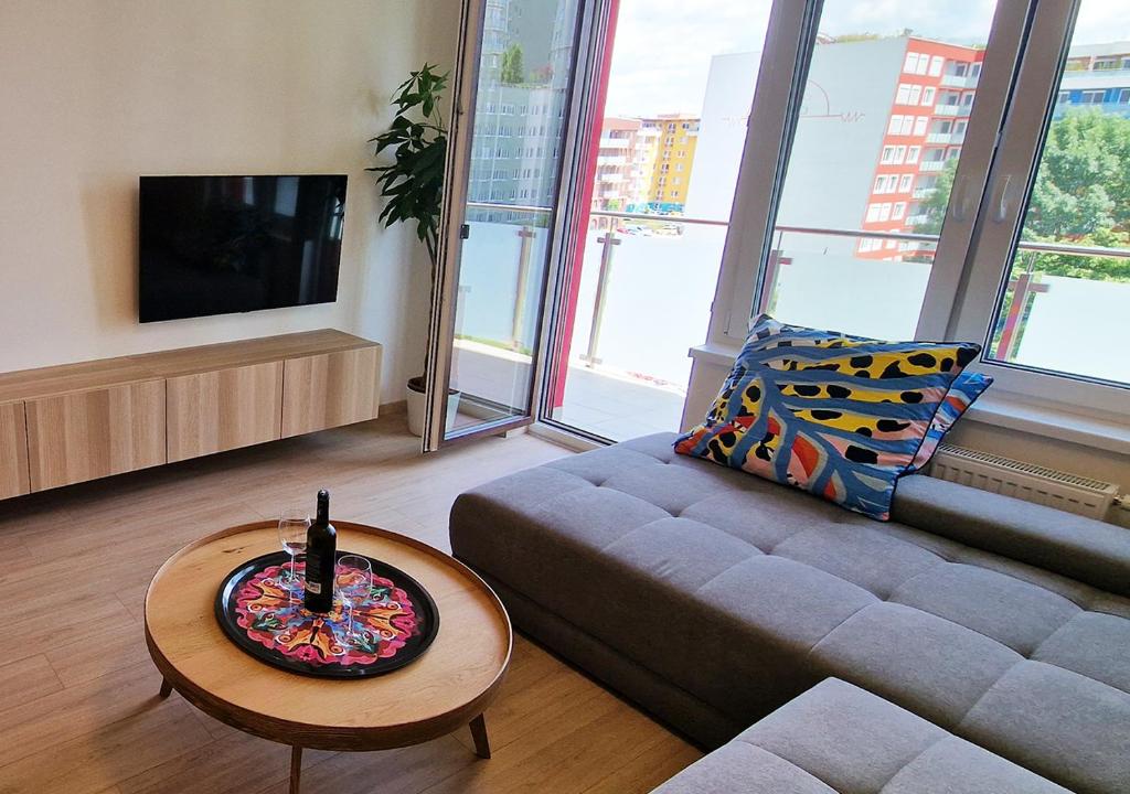 a living room with a couch and a table at Luxury Grand Apartments by Bratislavatrip in Bratislava