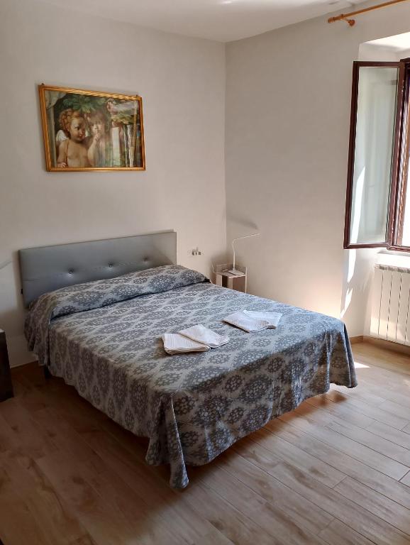 a bedroom with a bed with two towels on it at Casa Vacanze Le Cannelle in Montefiascone