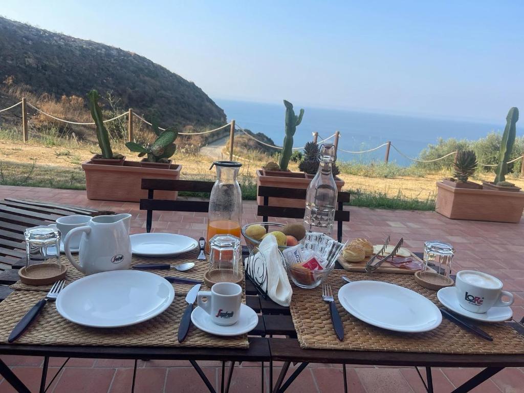 a wooden table with plates of food on it at B&B La Torre in Realmonte