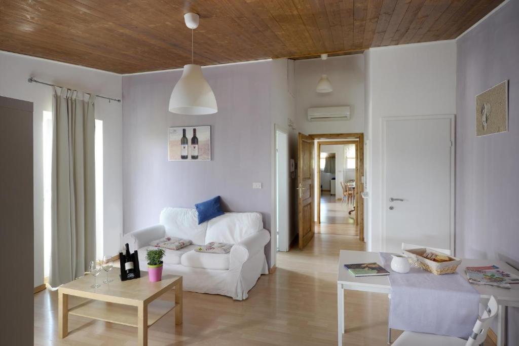 a living room with a white couch and a table at Tenuta PARAVANO in Povoletto
