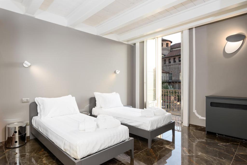 Ένα ή περισσότερα κρεβάτια σε δωμάτιο στο Q71 TIMELESS SUITES