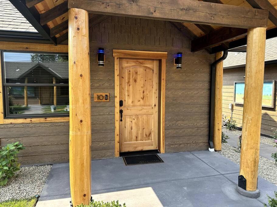 a wooden house with a door and a porch at Bear Mountain Suite 10 in Grants Pass