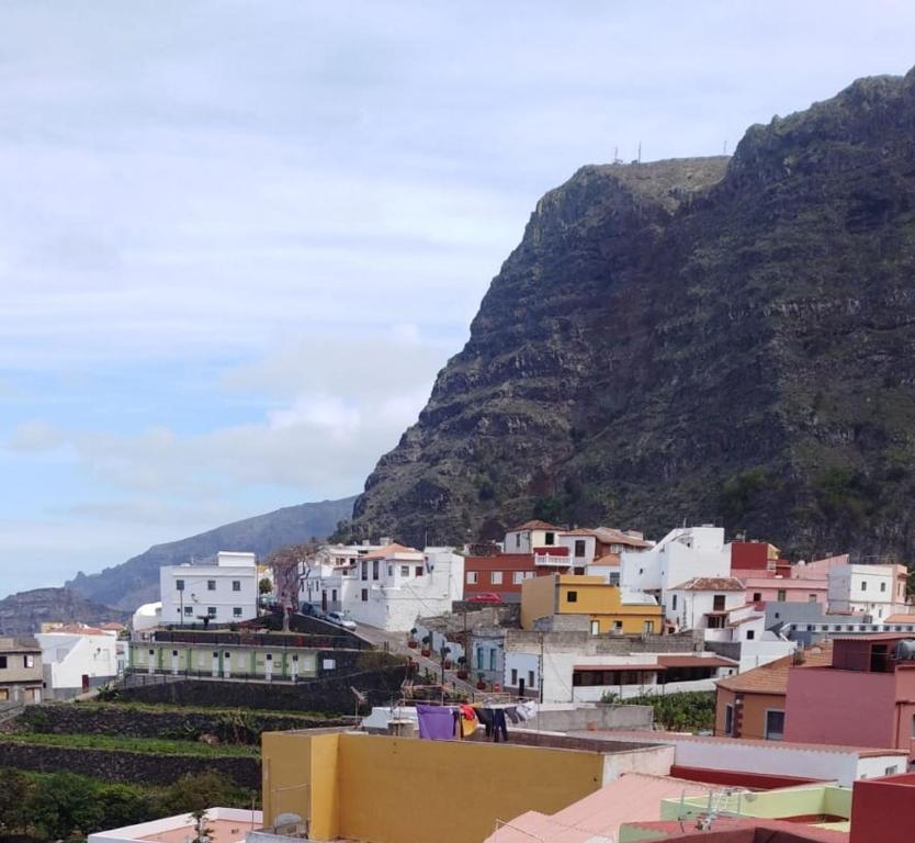 a group of buildings in front of a mountain at CASA ROSAMAR in Agulo