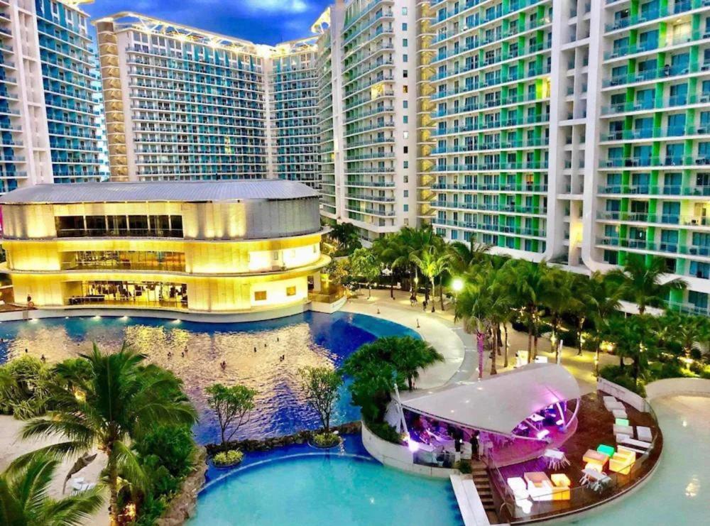 an aerial view of a resort with a pool and buildings at 1 Bedroom Unit with Massage Chair, Karaoke, Smart TV at Azure Urban Resort in Manila