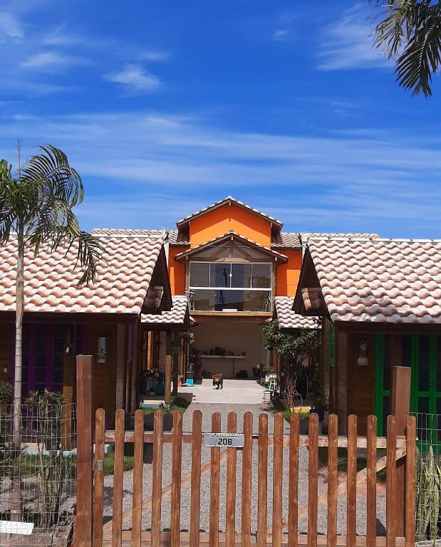 a house with a fence in front of it at Jajá Cabanas in Palhoça