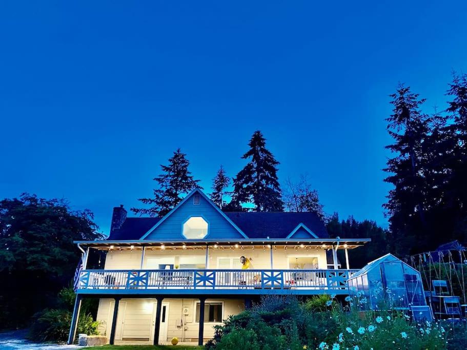 a large house with a balcony on the side of it at Stunning Home, Sound View, Sauna and Covered Deck in Vashon