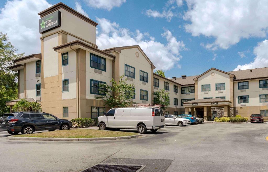 a hotel with cars parked in a parking lot at Extended Stay America Select Suites - Orlando - Maitland - 1760 Pembrook Dr in Orlando