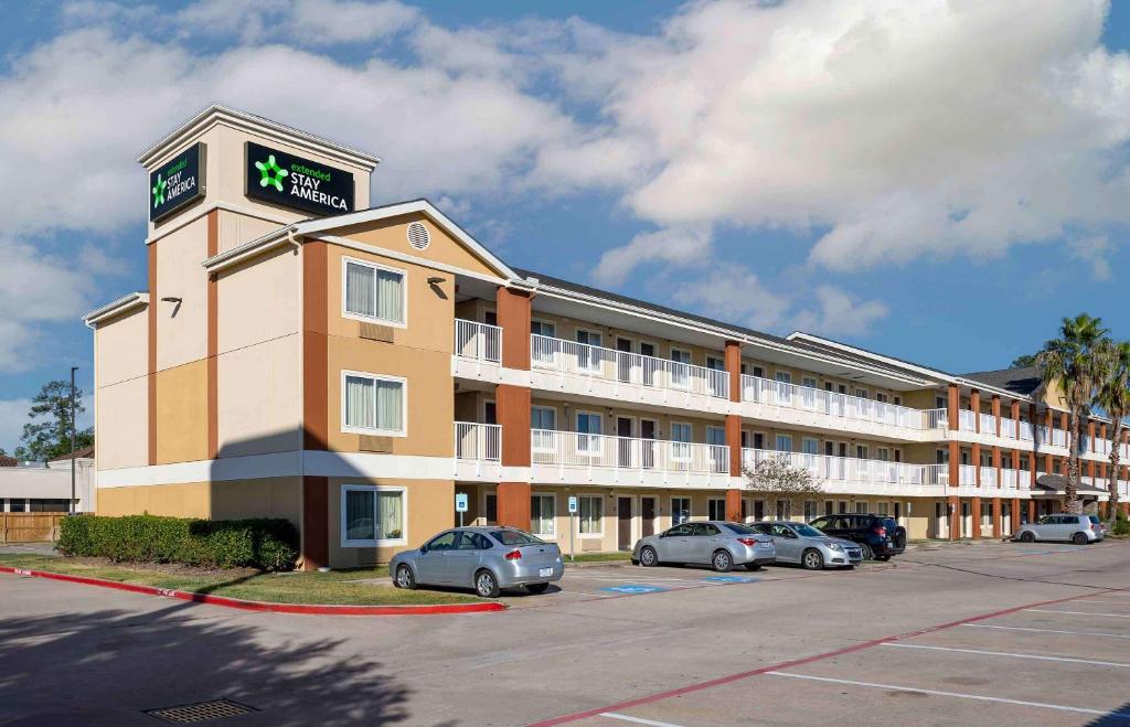 a hotel building with cars parked in a parking lot at Extended Stay America Suites - Houston - The Woodlands in The Woodlands