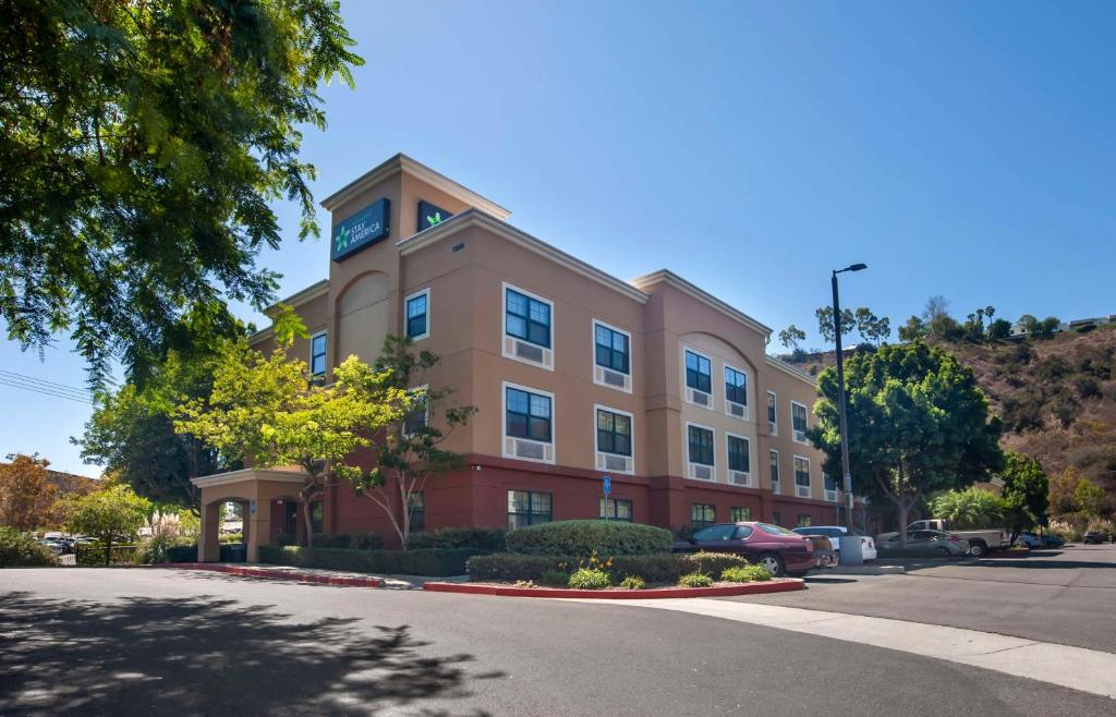 a tan building with a clock on top of it at Extended Stay America Suites - San Diego - Mission Valley - Stadium in San Diego