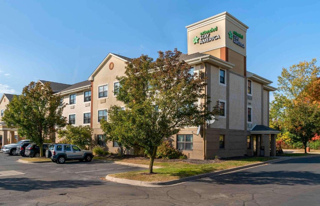 a hotel with a car parked in a parking lot at Extended Stay America Suites - Detroit - Canton in Canton