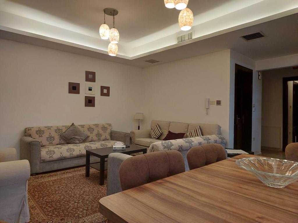 a living room with a couch and a table at Elegant Home in Amman
