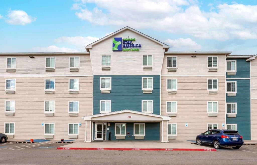 a large hotel with a car parked in a parking lot at Extended Stay America Select Suites - El Paso - East in El Paso