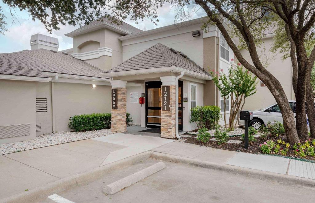 a house with a car parked in front of it at Extended Stay America Suites - Dallas - Coit Road in Dallas