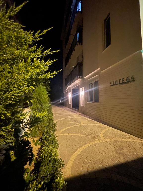 a building with lights on the side of it at night at Suite64 Apartments in Antalya
