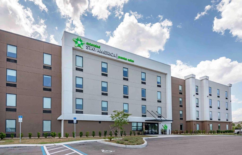 a building with a sign on the side of it at Extended Stay America Premier Suites - Melbourne - Palm Bay in West Melbourne