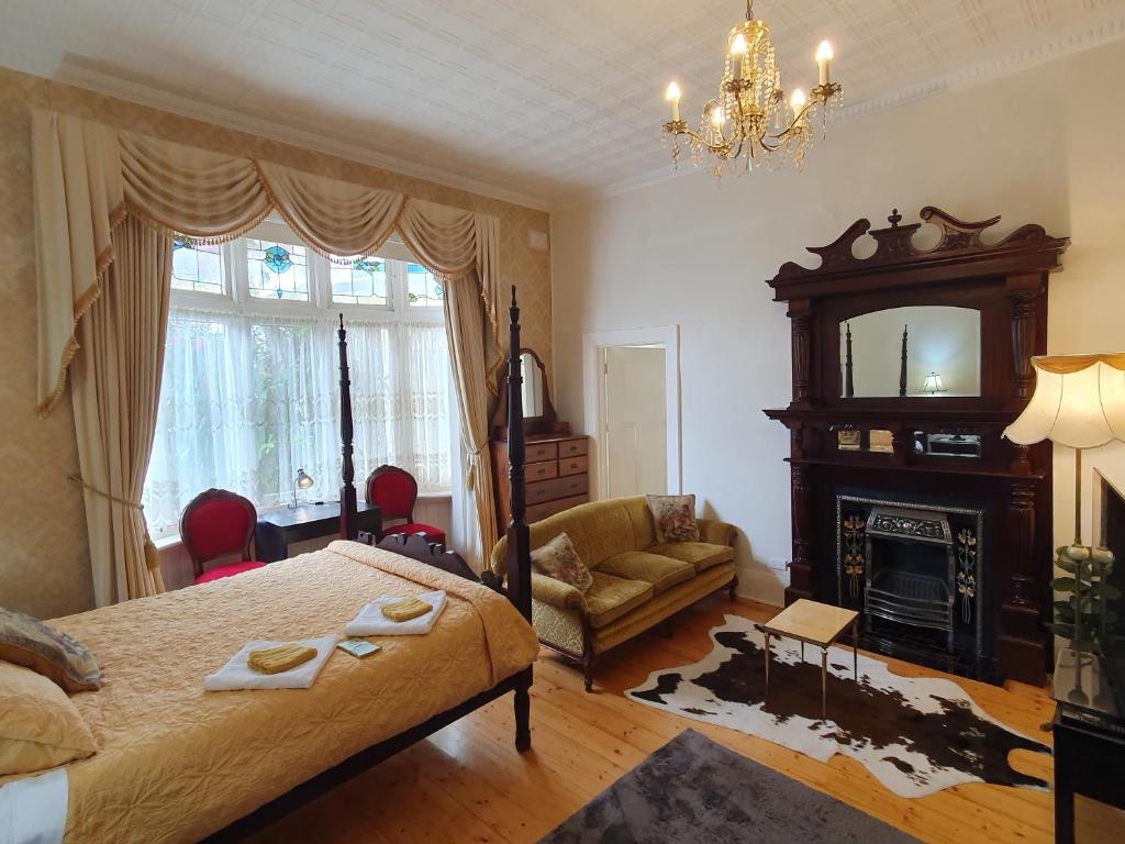 a bedroom with a large bed and a fireplace at Outstanding property Close to Melb Airport in Melbourne