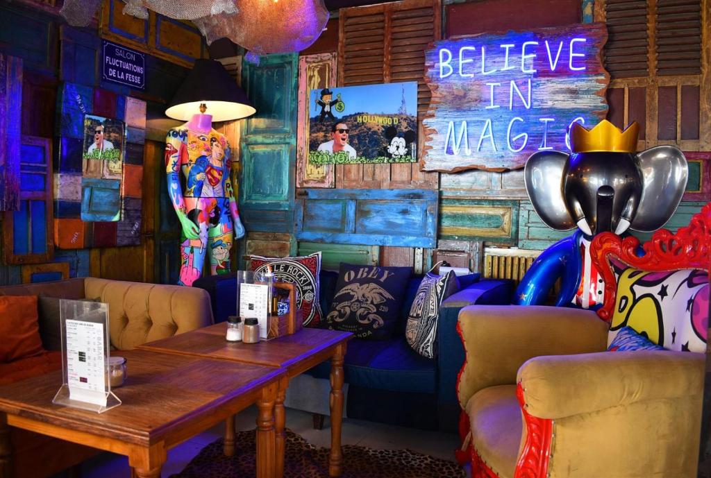 a room with a blue couch and a table at Hotel Beaurivage in Noumea