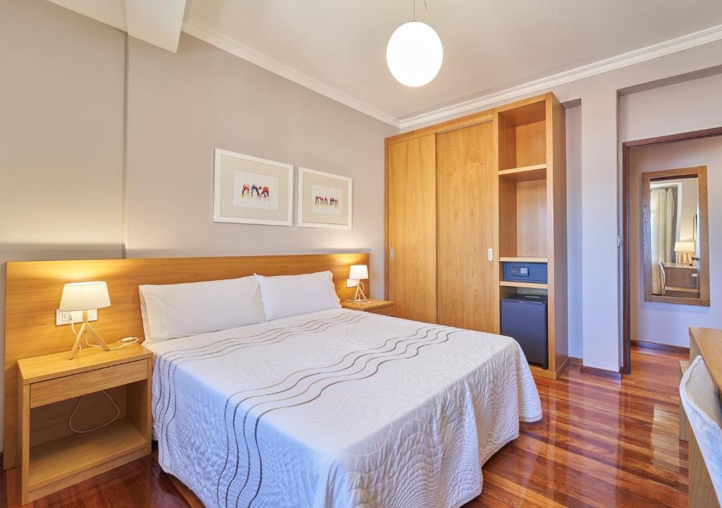 モアーニャにあるHotel Prado Viejoのベッドルーム1室(大型ベッド1台、白い毛布付)