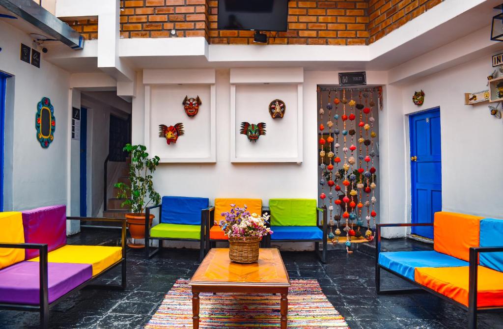 a colorful patio with colorful chairs and a table at Saqray Hostel in Cusco