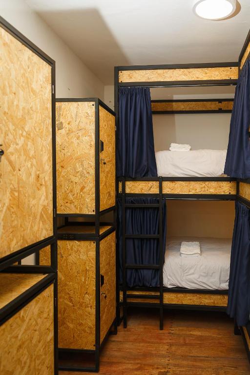 a room with two bunk beds in a room at Saqray Hostel in Cusco