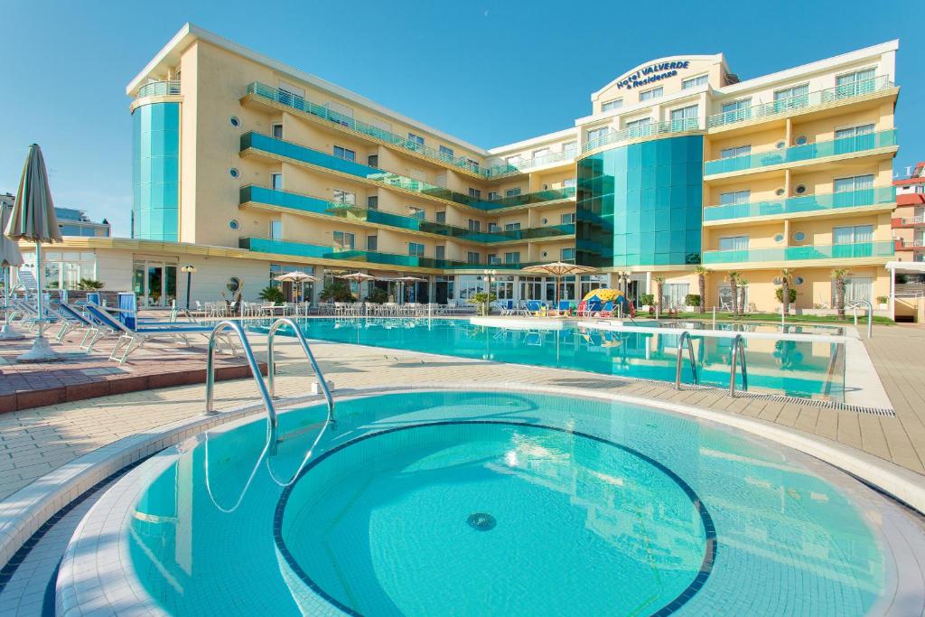 a swimming pool in front of a hotel at Hotel Valverde & Residenza in Cesenatico