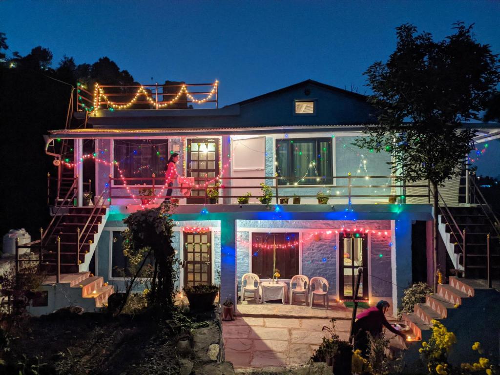 a house with christmas lights on the roof at Manu home stay in Almora