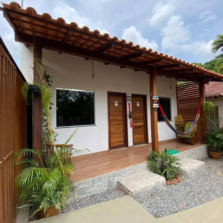 a house with a wooden porch with a roof at Casa Carauarí in Alter do Chao