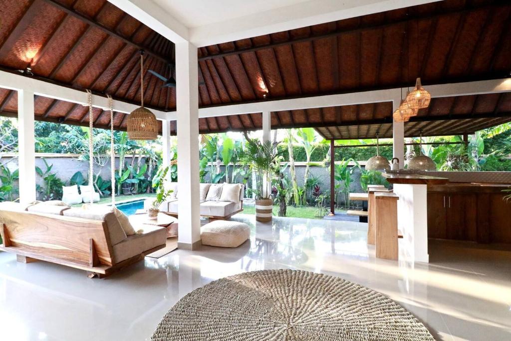a living room with a couch and a table at Villa Santai in Seminyak