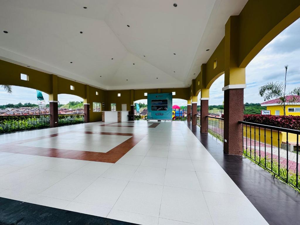 a hallway of a building with a white tile floor at Camella Homes Communal near Davao Airport in Davao City