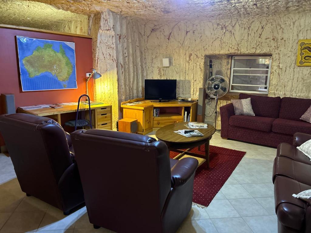 a living room with a couch and a table at Down to Erth B&B in Coober Pedy