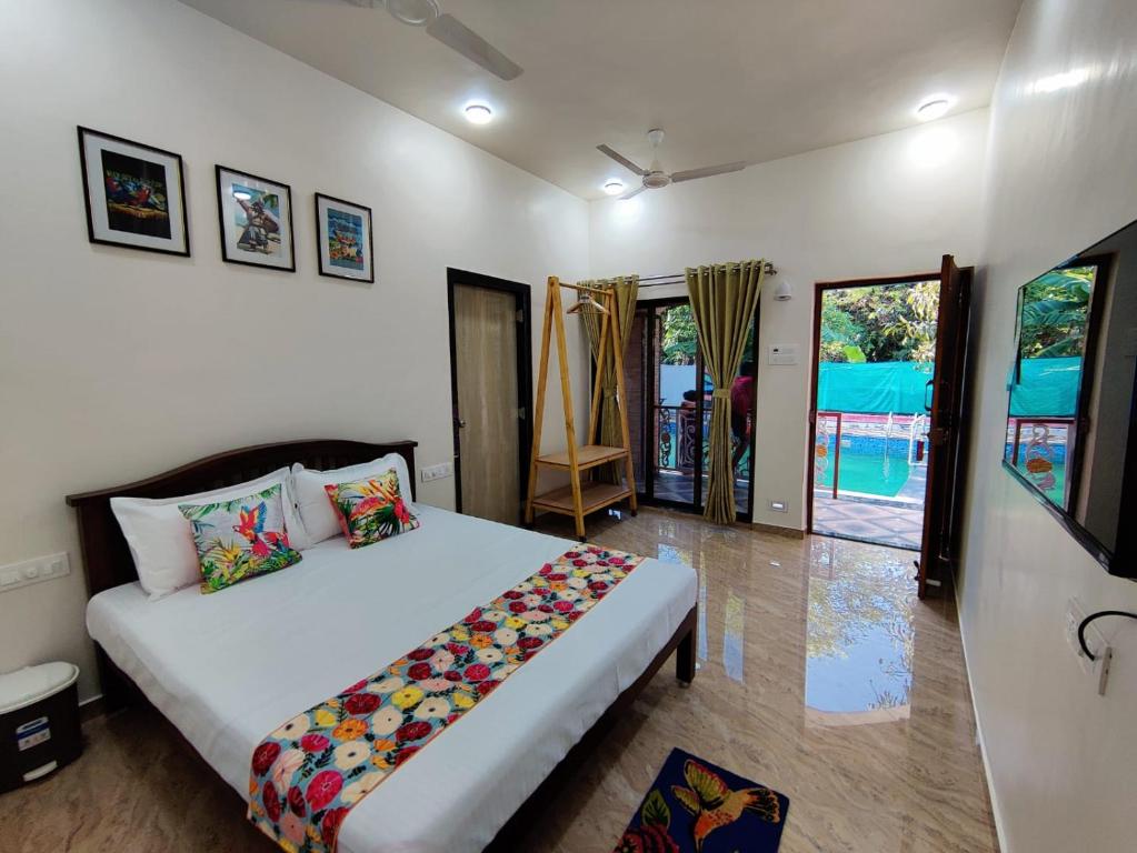 a bedroom with a large white bed in a room at Resort - Toms Hideout in Mumbai