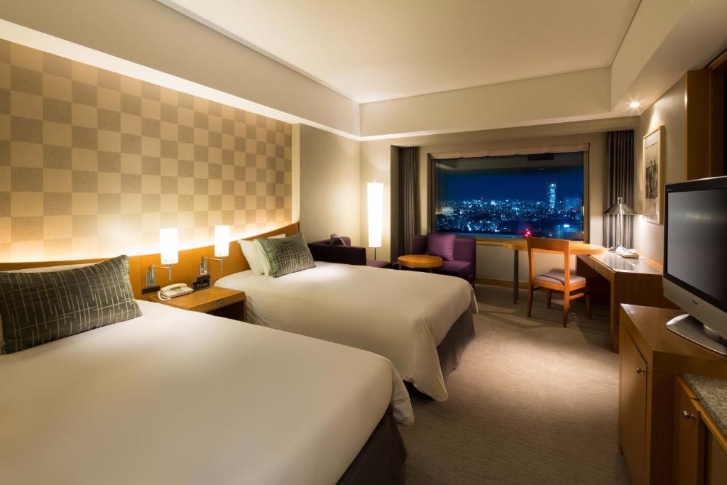 a hotel room with two beds and a television at Cerulean Tower Tokyu Hotel, A Pan Pacific Partner Hotel in Tokyo