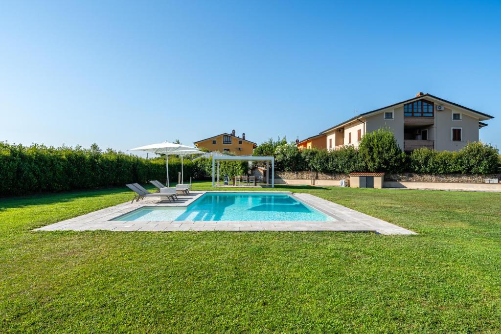 een zwembad in een tuin met een huis bij Villa Deluxe Giusti in Pescia