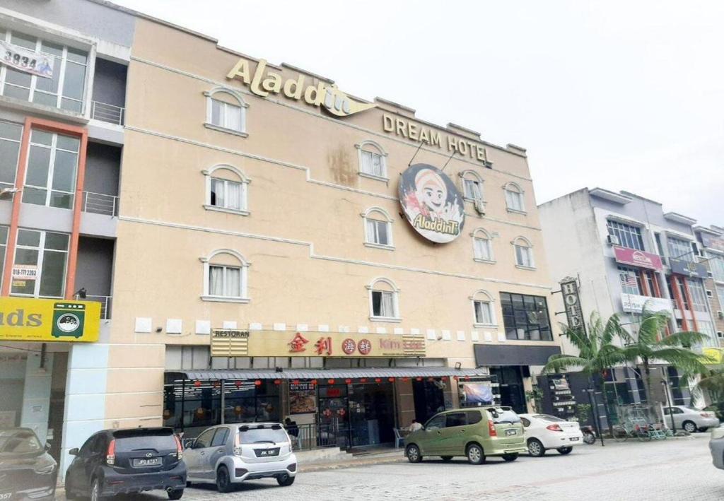 a building on a street with cars parked in front of it at Aladdin Dream Hotel in Johor Bahru