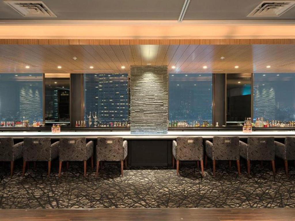 a bar in a hotel with a view of the city at Shinjuku Prince Hotel in Tokyo