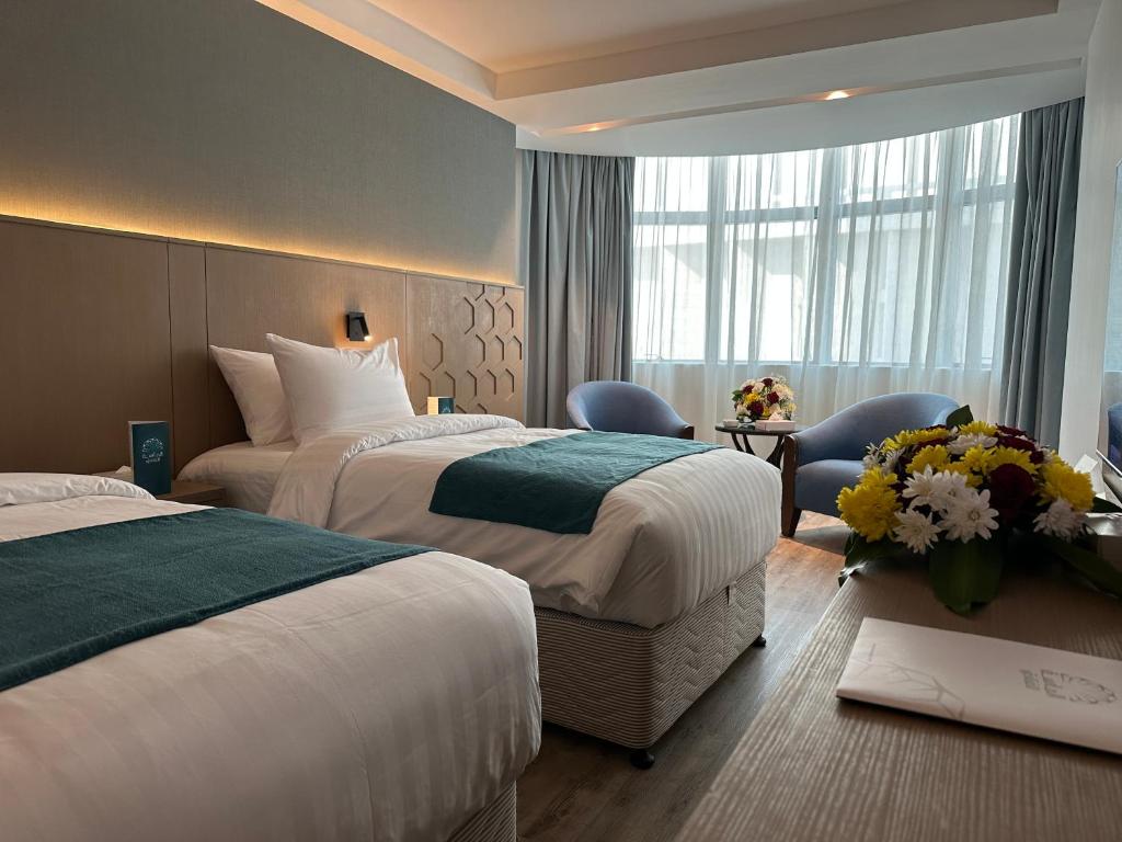 En eller flere senge i et værelse på Al Massa Grand Hotel