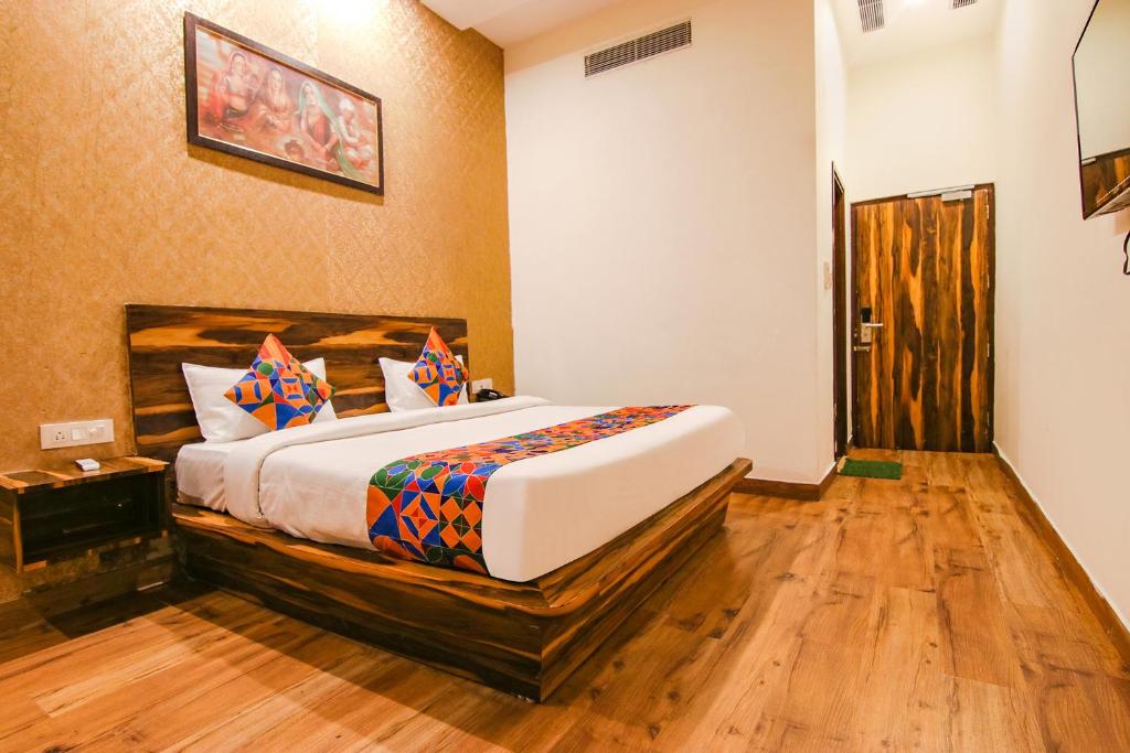 a bedroom with a large bed in a room at FabHotel Sallow Grand in Amritsar