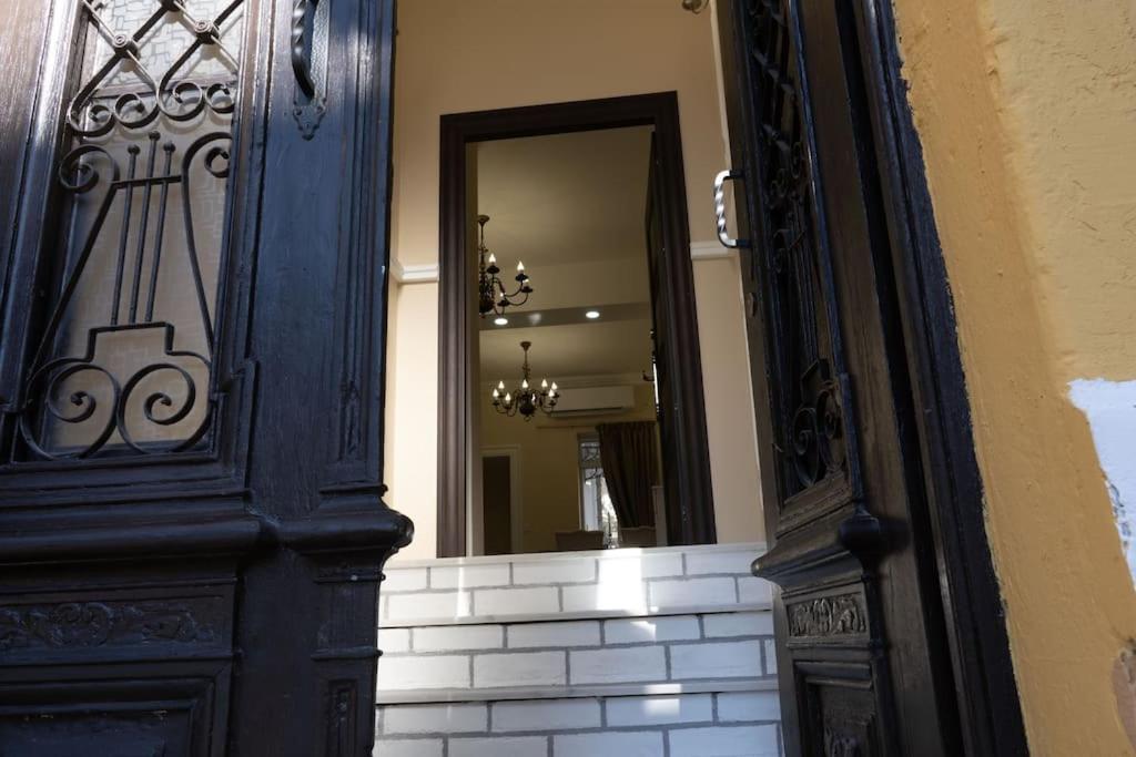 a blue door with a mirror in a building at Iconic House Plovdiv in Plovdiv