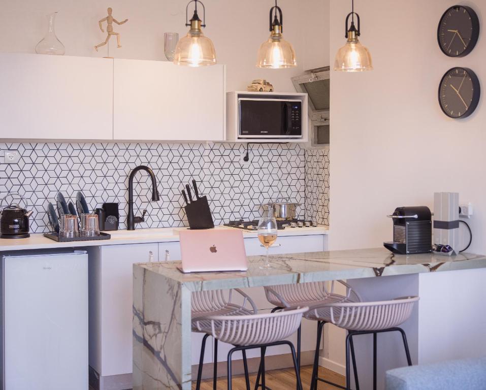 a kitchen with a counter with a laptop on it at Golden Beach / De Shalit in Herzliyya B
