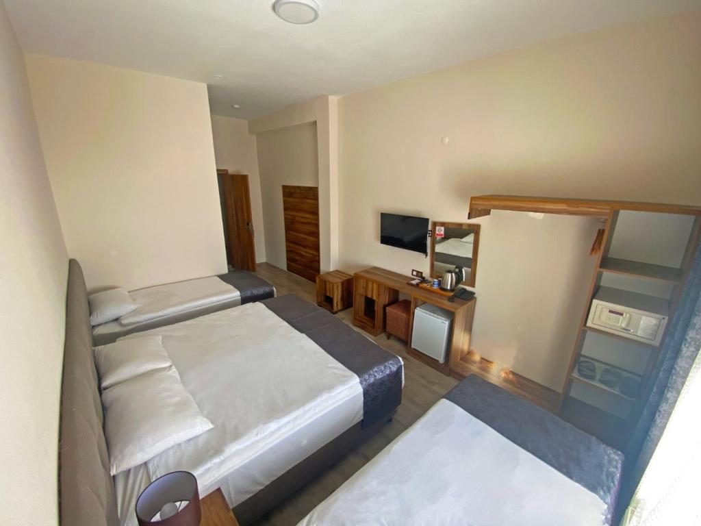 Кровать или кровати в номере Zümrüt Palas Otel