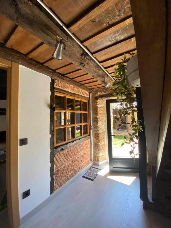 a room with a door leading to a building at Las Casas de Quintanilla 3 in Quintanilla las Torres